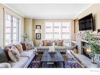 Bright living room featuring large windows, fireplace, sofas, and an area rug at 1301 Canyon Blvd # 207, Boulder, CO 80302