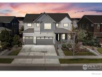 Beautiful two-story home with a well-maintained lawn, two-car garage and mature trees at 1840 Marquette Dr, Erie, CO 80516