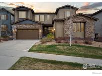 Charming two-story home with a stone facade and a well-manicured front yard at 25190 E Nova Pl, Aurora, CO 80016