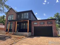 New construction showcasing brick and black metal accents, two-car garage, and modern design elements at 2941 21St St, Boulder, CO 80304