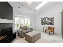 Bright living room featuring a fireplace, comfortable seating, and natural light from a window at 3090 W 107Th Pl # C, Westminster, CO 80031