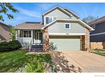 Charming two-story home featuring a stone facade, attached garage, and a welcoming front porch at 4856 10Th St, Boulder, CO 80304