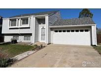 Two-story home featuring an attached two-car garage and a well-maintained front yard and modern architecture at 5958 S Swadley Way, Littleton, CO 80127