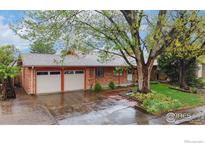 Charming single-story brick home with a two-car garage and mature landscaping at 6432 Owens St, Arvada, CO 80004