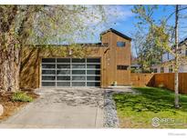 Contemporary two-story home with a garage featuring a glass door and modern architectural design at 711 Hawthorn Ave, Boulder, CO 80304