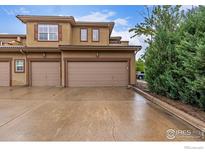 Two-car garage with neutral color doors and updated stucco exterior at 7777 E 23Rd Ave # 1406, Denver, CO 80238