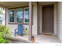 Inviting front porch with a blue chair and a neutral-colored exterior, creating a cozy entrance at 812 E Baseline Rd # A, Lafayette, CO 80026