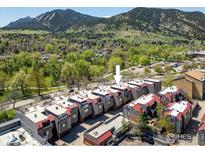 Beautiful aerial view of townhomes with mountain backdrop and lush green trees, showing community and location at 836 Walnut St # B, Boulder, CO 80302