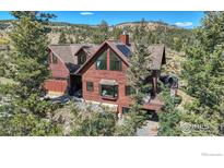 Beautiful two-story home with a covered porch, attached garage, and mature landscaping at 98 Rim Rd, Boulder, CO 80302