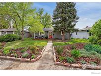 Charming single-story home with landscaped front yard and inviting red door at 1343 Gay St, Longmont, CO 80501