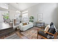 Bright living room featuring modern decor, neutral tones, and hardwood floors at 1684 Holeman Dr, Erie, CO 80516