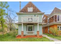 Charming two-story home featuring a balcony, bay window, and quaint architectural details at 1837 Walnut St # E, Boulder, CO 80302