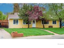 Charming single-story home featuring a well-maintained lawn, mature trees, and a welcoming front entrance at 3090 17Th St, Boulder, CO 80304