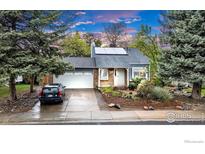 Charming home featuring solar panels, well-kept lawn, and a two-car garage at 323 S Hoover Ave, Louisville, CO 80027