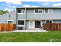 Two-story home featuring an outdoor patio, lawn, and wood fence at 4160 Monroe Dr # B, Boulder, CO 80303