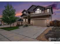 Inviting two-story home showcasing a well-manicured lawn and an attached two-car garage at sunset at 6725 2Nd St, Frederick, CO 80530