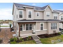 Charming two-story home with neutral siding, a covered front porch, and well-maintained landscaping at 685 Crossbill Dr, Berthoud, CO 80513