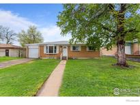 Charming single-story home with brick facade and well-maintained lawn, inviting curb appeal at 690 W 1St Ave, Broomfield, CO 80020