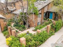 Charming home featuring landscaped garden with mature trees and a welcoming brick pathway leading to the front door at 700 Poplar Ave, Boulder, CO 80304