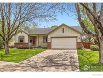 Charming single-Gathering home with a well-manicured front yard and a two-car garage at 741 Hallmark Ln, Longmont, CO 80504