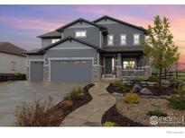Beautiful two-story home with a three-car garage and a landscaped front yard at 916 Rocky Ridge Cir, Erie, CO 80516