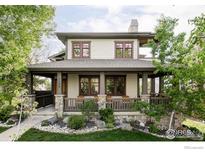 Charming two-story home with a covered front porch and manicured landscaping, offering great curb appeal at 1108 Grant Ave, Louisville, CO 80027