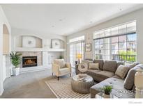 Bright living room features a fireplace, ample natural light, and comfortable seating at 12711 Colorado Blvd # H-804, Thornton, CO 80241
