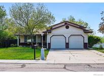 Charming single-Gathering home showcasing a well-maintained lawn and an attached two-car garage at 1839 Stratford Ln, Longmont, CO 80503