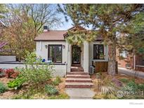 Charming single-Gathering home featuring a red tile roof and meticulously maintained front yard at 229 Albion St, Denver, CO 80220