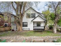 Charming two-story home featuring a covered front porch, a well-manicured lawn and mature trees in a desirable neighborhood at 2315 Walnut St, Boulder, CO 80302