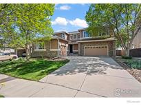 Charming two-story home with a well-manicured lawn and a spacious driveway leading to a two-car garage at 2458 Vale Way, Erie, CO 80516