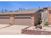 Charming townhome with a two-car garage and well-maintained landscaping, offering a cozy curb appeal at 2875 W Davies Ave, Littleton, CO 80120