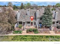 Charming townhouse featuring a fenced yard with lovely landscaping and a cozy outdoor patio area at 305 S Taft Ct, Louisville, CO 80027