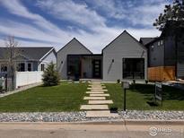 Charming home featuring a well-manicured lawn and a modern exterior design with stone walkway at 306 S 3Rd Ave, Superior, CO 80027