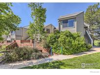 Charming townhouse exterior with well-maintained landscaping and brick accents at 3260 47Th St # 201A, Boulder, CO 80301