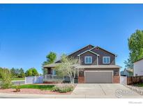 Charming two-story home featuring a well-maintained front yard, and two-car garage, perfect for suburban living at 3530 Homestead Dr, Mead, CO 80542