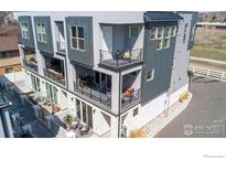 Modern multi-story condo with balconies, showcasing a sleek architectural design and outdoor living spaces at 7861 W 51St Ave, Arvada, CO 80002