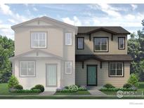Charming two-story home with a front yard and inviting teal front door at 1450 Coral Pl, Longmont, CO 80504