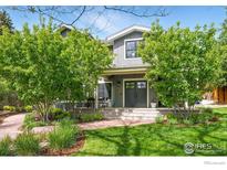 Charming two-story home featuring a covered porch and mature landscaping at 3059 6Th St, Boulder, CO 80304
