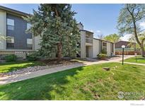 A condo community featuring mature trees, a sidewalk, and lush green lawns on a sunny day at 3515 28Th St # 201, Boulder, CO 80301