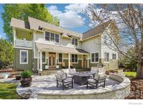 A beautiful outdoor living space with a stone patio and fire pit, perfect for entertaining guests at 474 W Spruce St, Louisville, CO 80027