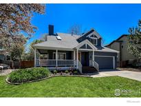 Charming two-story home featuring a covered front porch, manicured lawn, and attached two-car garage at 5978 Scotswood Ct, Boulder, CO 80301