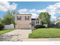 Charming home with a manicured lawn, attached garage, and inviting curb appeal at 710 Sedge Way, Lafayette, CO 80026