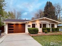 Charming one-story home with a lovely yard, a brown door, and a matching garage door at 714 S Longmont Ave, Lafayette, CO 80026
