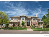 Beautiful two-story brick home with manicured lawn and front yard landscaping at 725 E Wiggins St, Superior, CO 80027