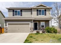 Charming two-story home featuring a two-car garage and meticulously maintained front yard at 920 Wagon Bend Rd, Berthoud, CO 80513