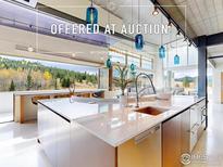 Modern kitchen with large island, stainless steel appliances, and a scenic view at 987 Lost Angel Rd, Boulder, CO 80302