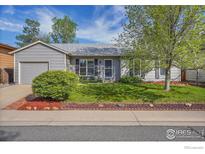 Charming single-story home with well-manicured lawn, inviting curb appeal, and mature landscaping at 1201 Stein St, Lafayette, CO 80026