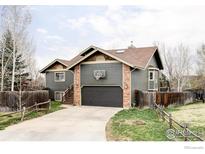 Charming two-story home with a basketball hoop above the garage, and split rail fence at 2770 Arbor Glen Pl, Boulder, CO 80304