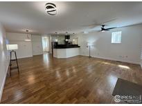 Spacious living room and kitchen featuring hardwood floors and modern lighting fixtures at 3440 W 33Rd Ave, Denver, CO 80211